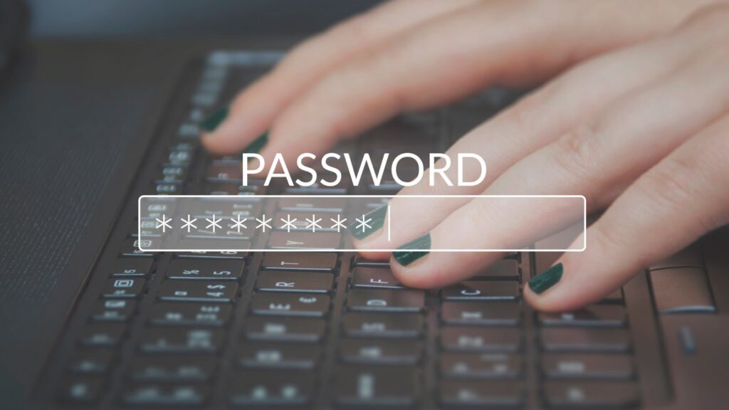 Close-up of hands typing on a laptop keyboard with a password entry field, highlighting the risk of bad actors exploiting massive database of passwords shown by obscured characters on the screen.